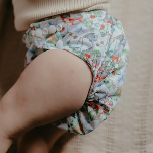 Toddler wearing Little Lamb One size pocket nappy in Toadally Unfrogettable