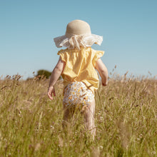 Load image into Gallery viewer, Toddler in a field wearing Little Lovebum Quickdry in Buttercup - All-in-One Cloth Nappy - Peanut and Poppet UK
